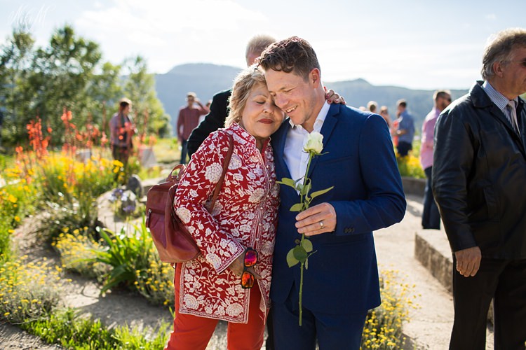 Tim embraces his mother as they leave the labyrinth after the wedding ceremony