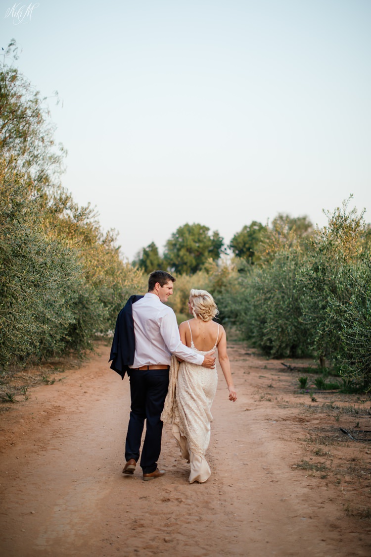 Couple walk through an olive grove in the Karoo town of Oudtshoorn