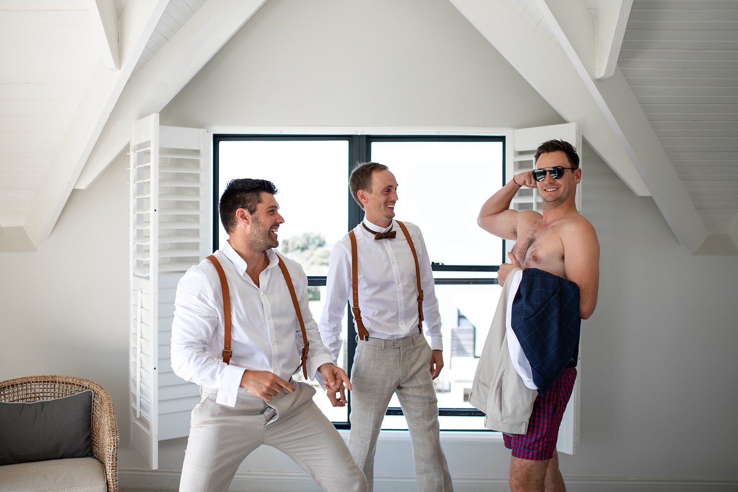 Natural wedding photographs of the groomsmen goofing around before getting dressed at The St Francis Links