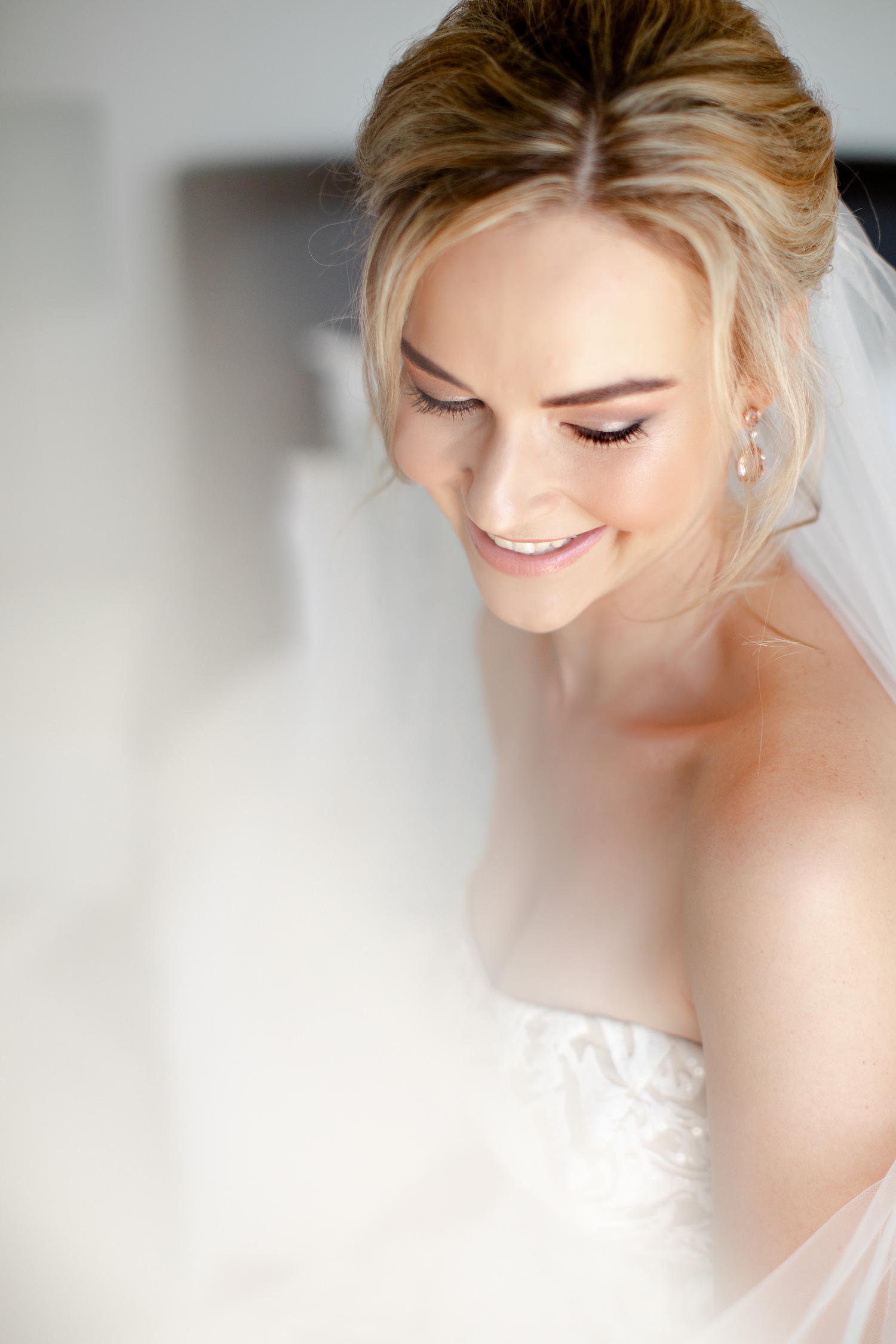 Classic bridal portrait of a blonde bride with updo and lace strapless dress