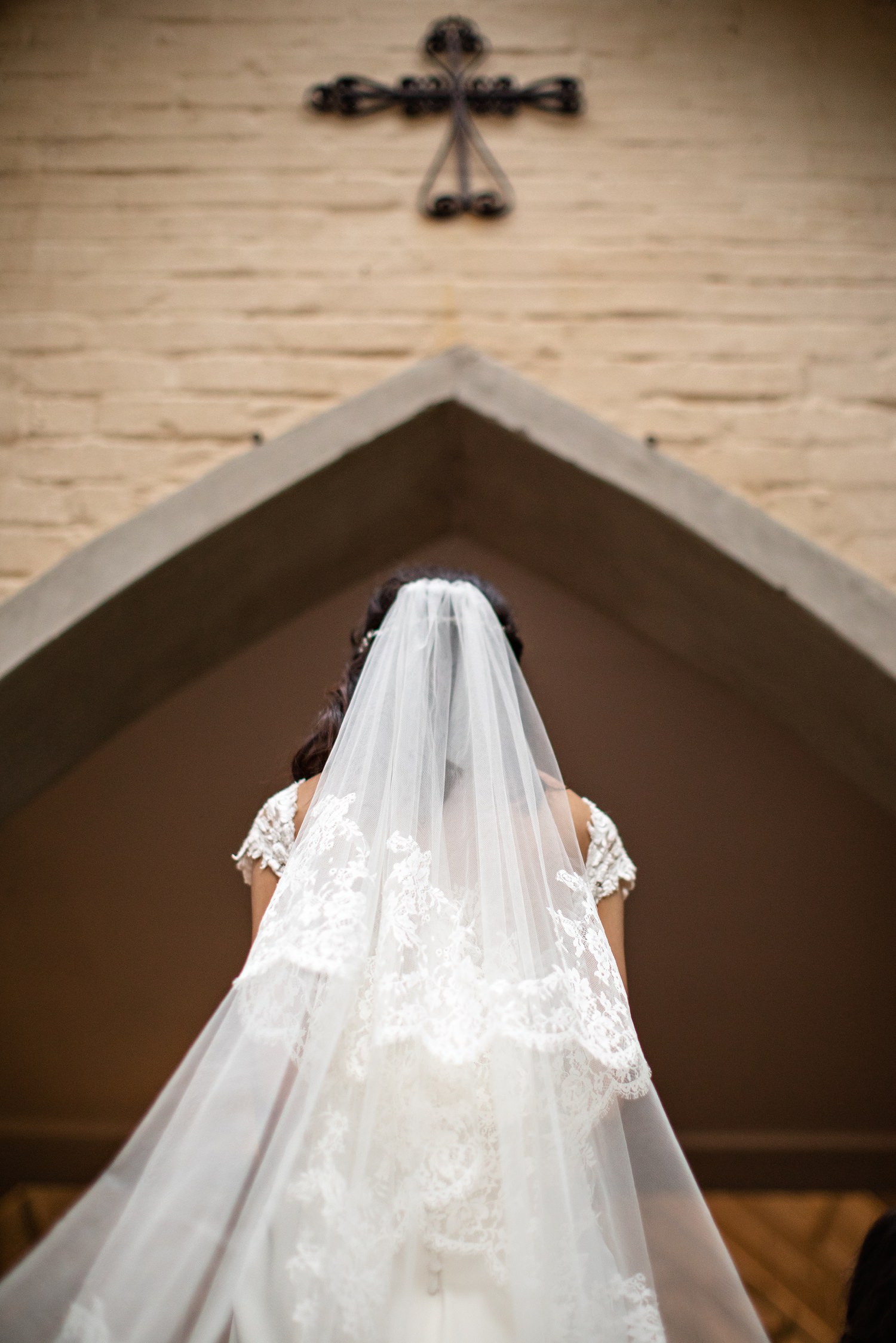 View from behind as the bride walks through the chapel arch at The Plantation Wedding Venue in Port Elizabeth