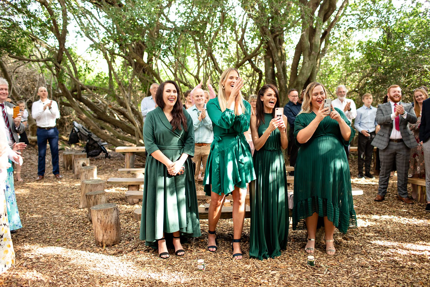 Wedding guests clap and cheer as the couple are pronounced husband and wife. Image by wedding photographer in South Africa, Niki M Photography