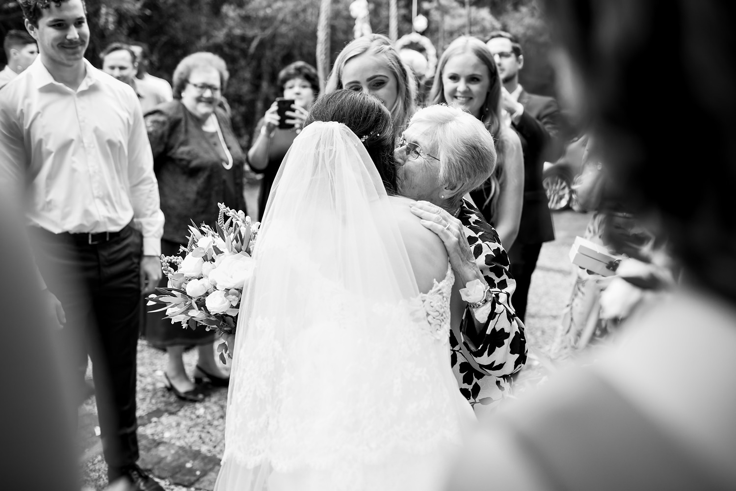 The bride has a tender moment with her grandmother as they embrace