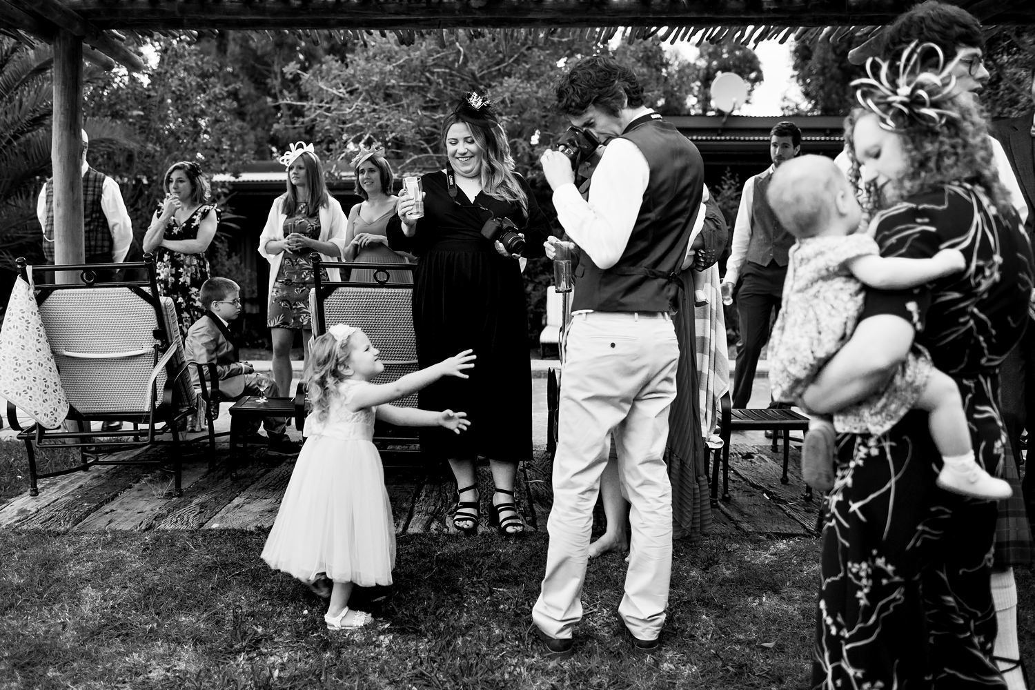 Keeping guests occupied during canapes creates beautiful moments for wedding photography as this father photographs his daughter playing and dancing
