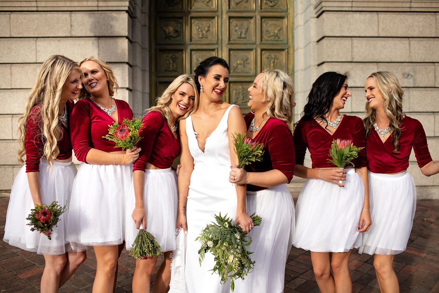 A beautiful moments with bride and bridesmaids at and inner city wedding in port elizabeth with maroon and white two piece bridesmaid dresses by wedding photographer in South Africa, Niki M Photography
