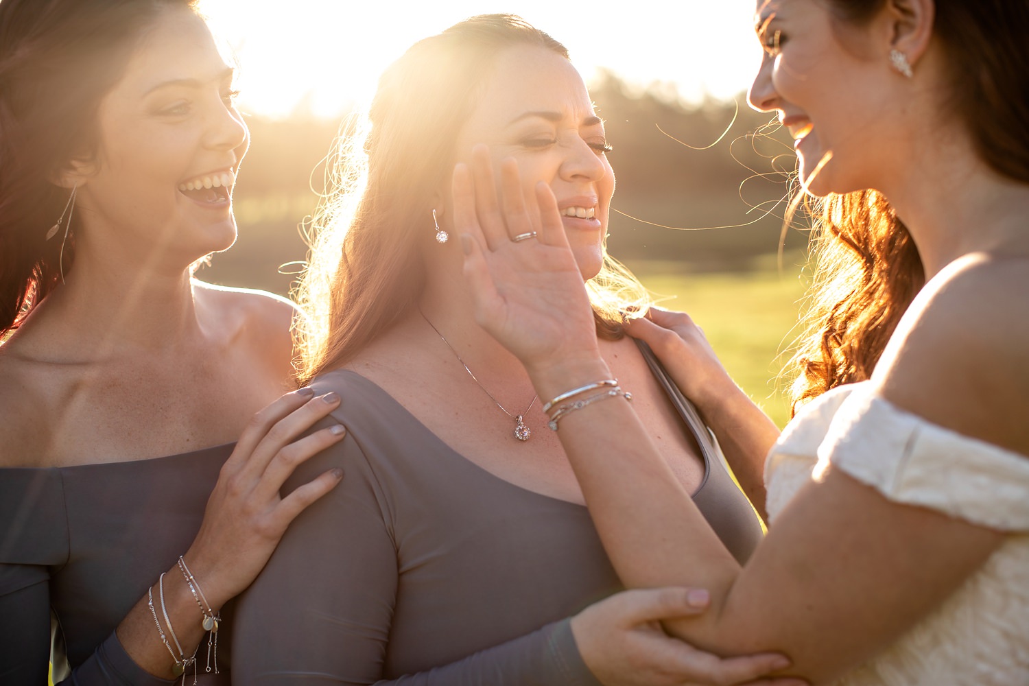 Wedding photographer in South Africa, Niki M Photography uses late afternoon sun to light up the bride and her bridesmaids as they laugh
