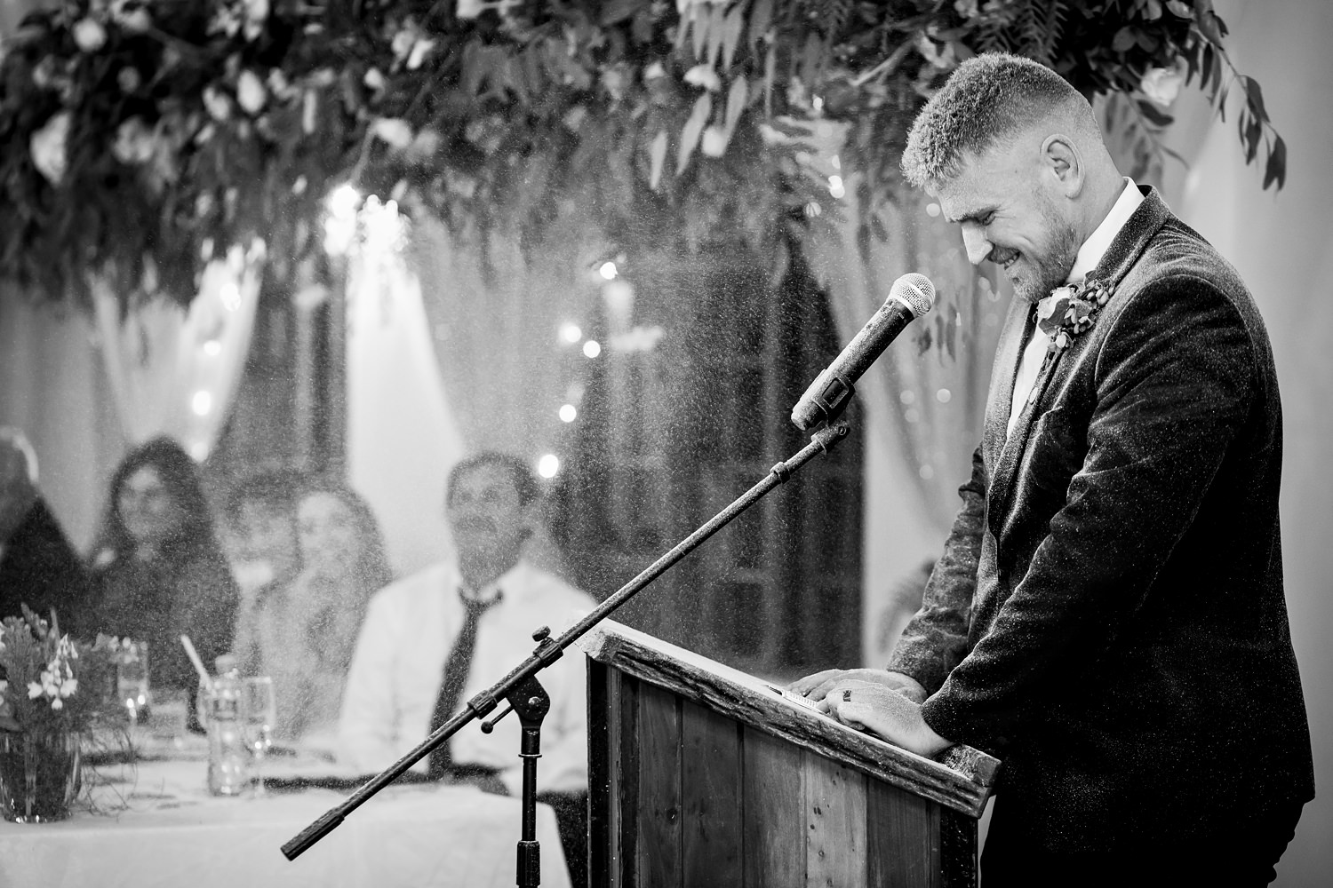 Groom tries to give his speech whilst being sprayed with snow foam spray during the wedding reception at Blomfontein wedding venue in the Karoo