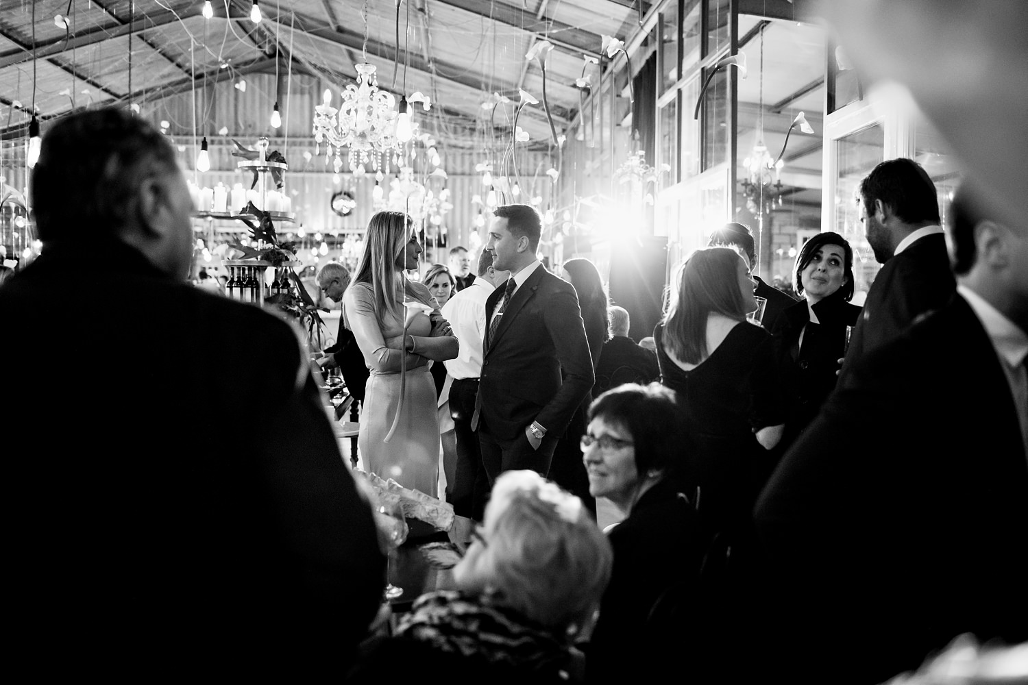 Documentary wedding photography scenes as guests mingle between courses at The Rose Barn wedding reception in Jeffrey's Bay
