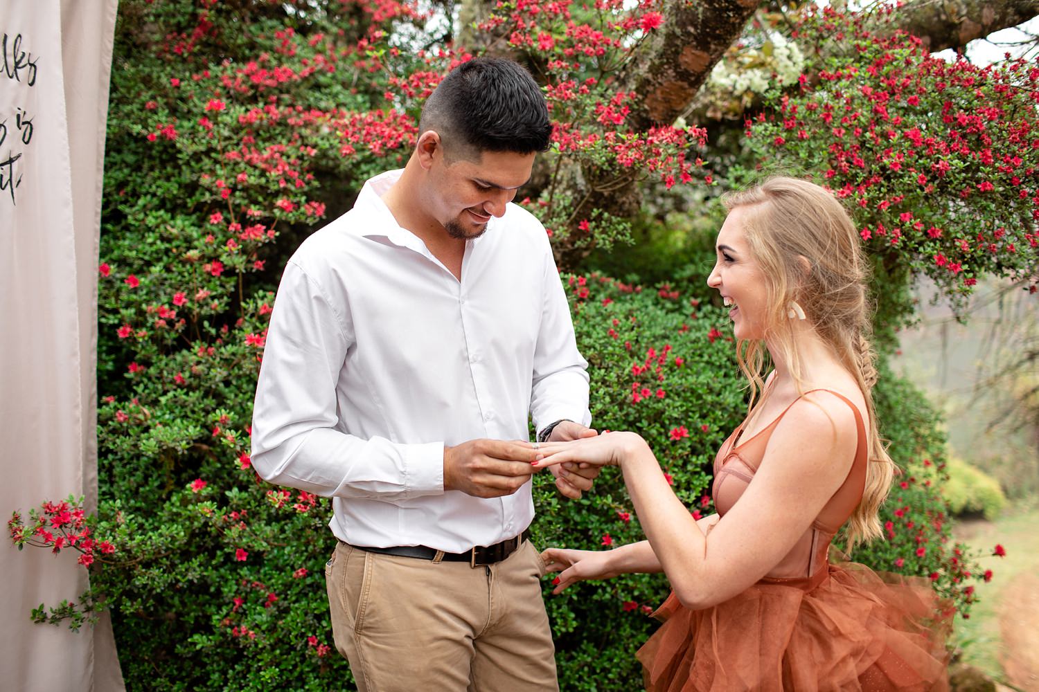 The groom places an agate and quartz ring on the bride's ring finger during their elopement.