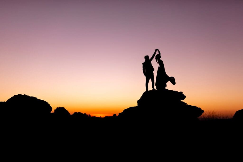 A sunset silhouette of Claudia and Charles at their Kaapsehoop wedding next to the Boulder fields.