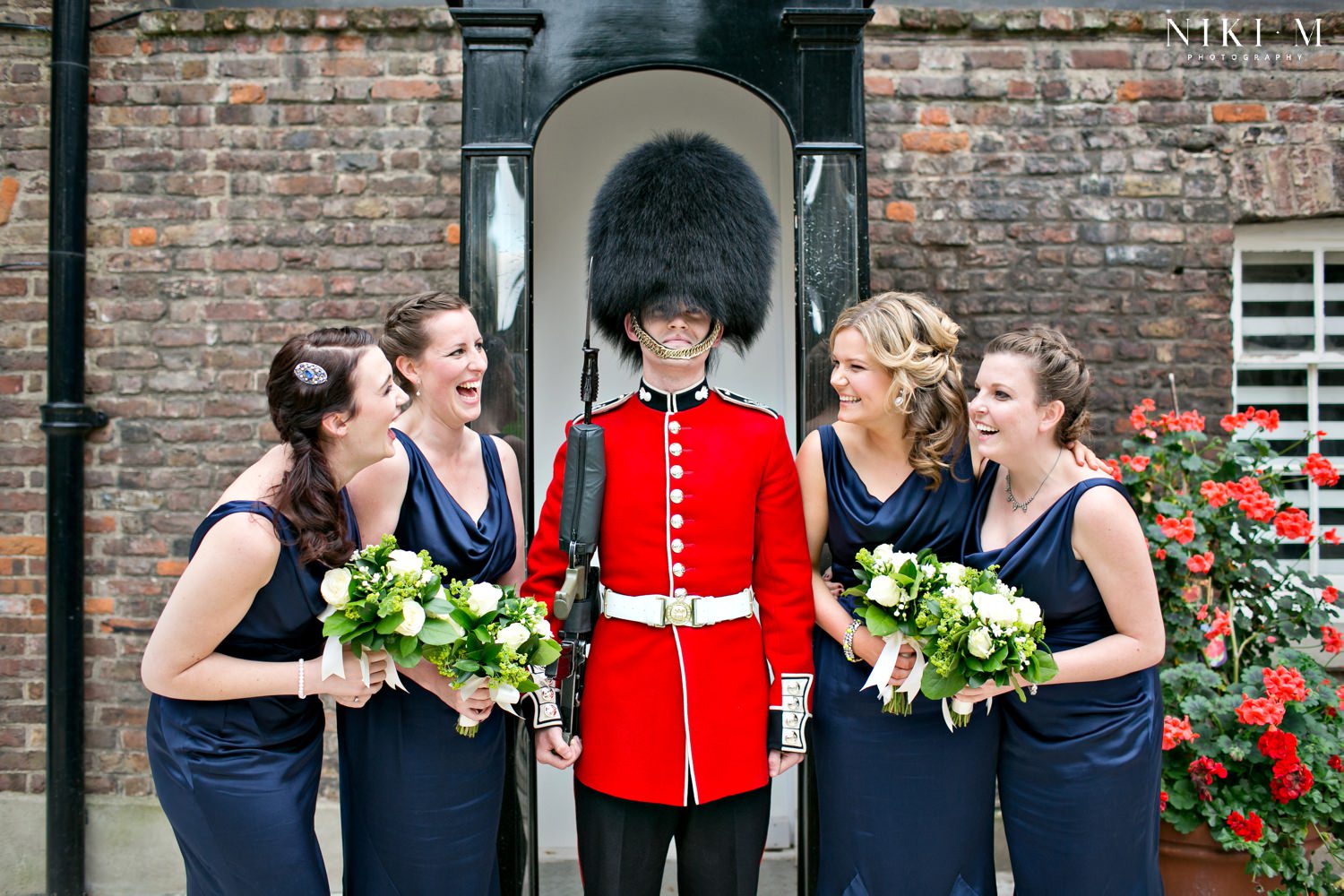 Bridesmaids with a Tower Guard/ Beefeater at a Tower of London wedding
