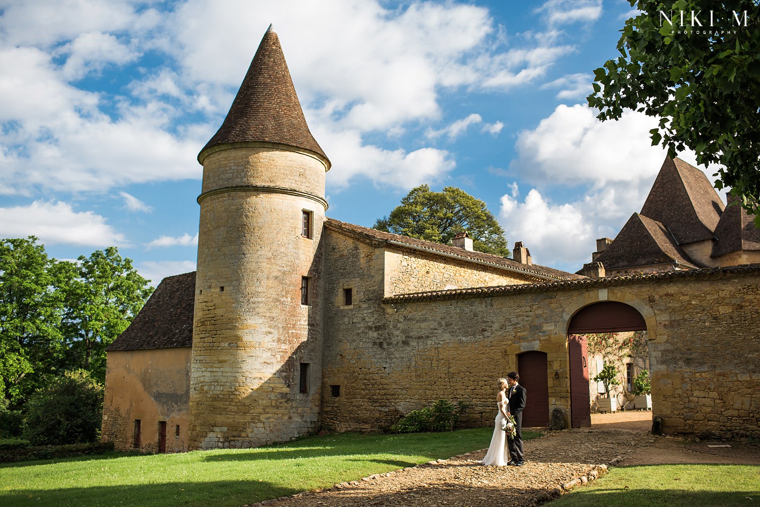 Bride and groom in front of Chateau de la Bourlie Dordogne wedding venue