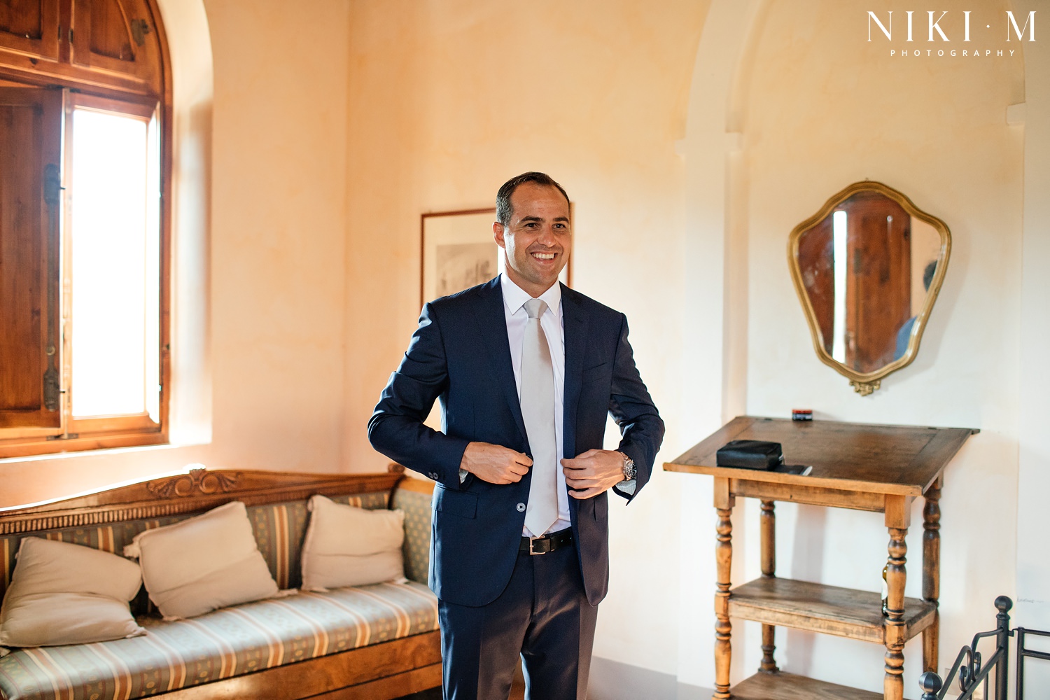 A groom gets ready before the big day at his Tuscany wedding venue, Villa Ricrio