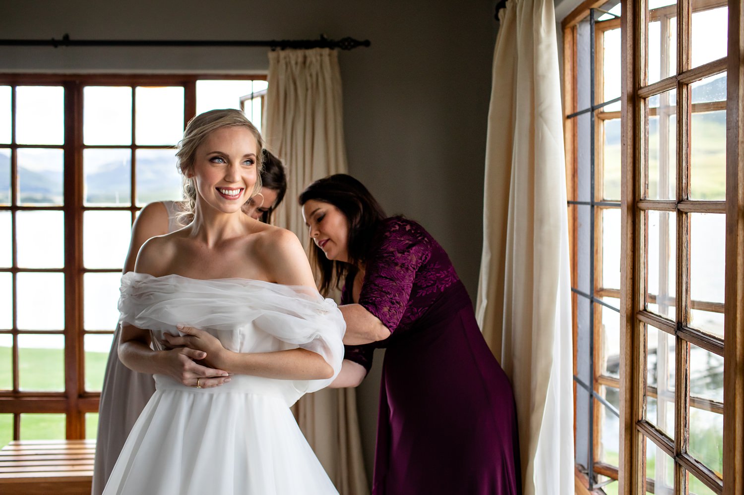 A bride gets dressed for her adventurous Drakensberg elopement/micro-wedding