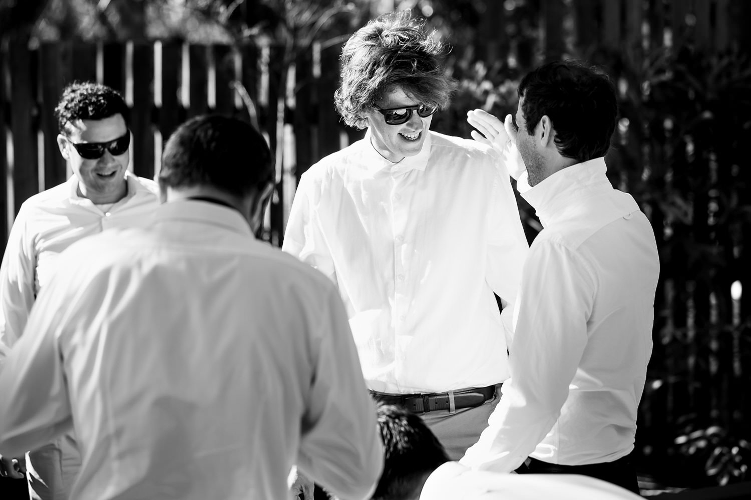 Groomsmen greet each other in this black and white images taken at Cherry Glamping during an Elgin Wedding