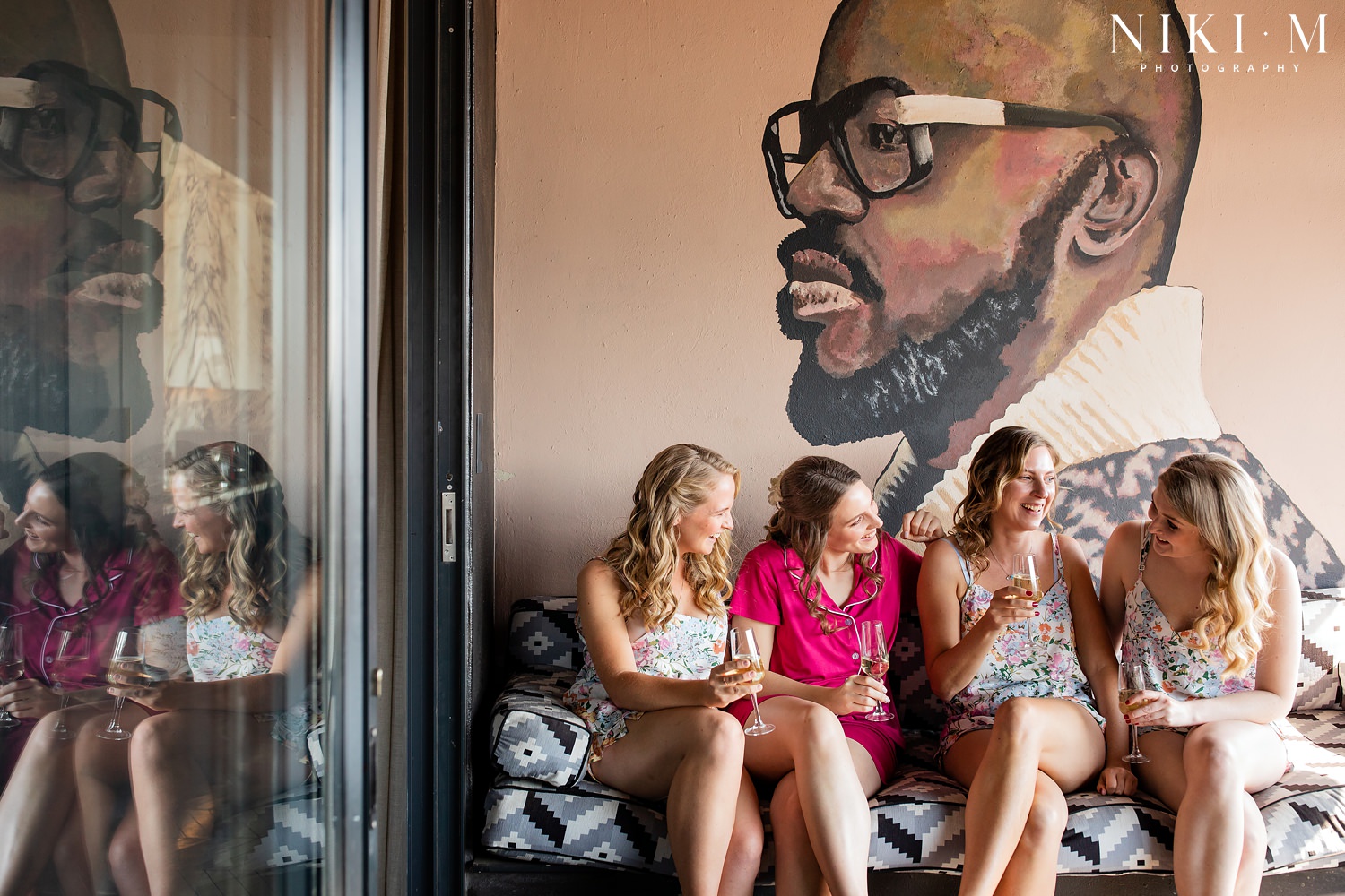Bride and bridesmaids with Black Coffee mural at Johannesburg Wedding