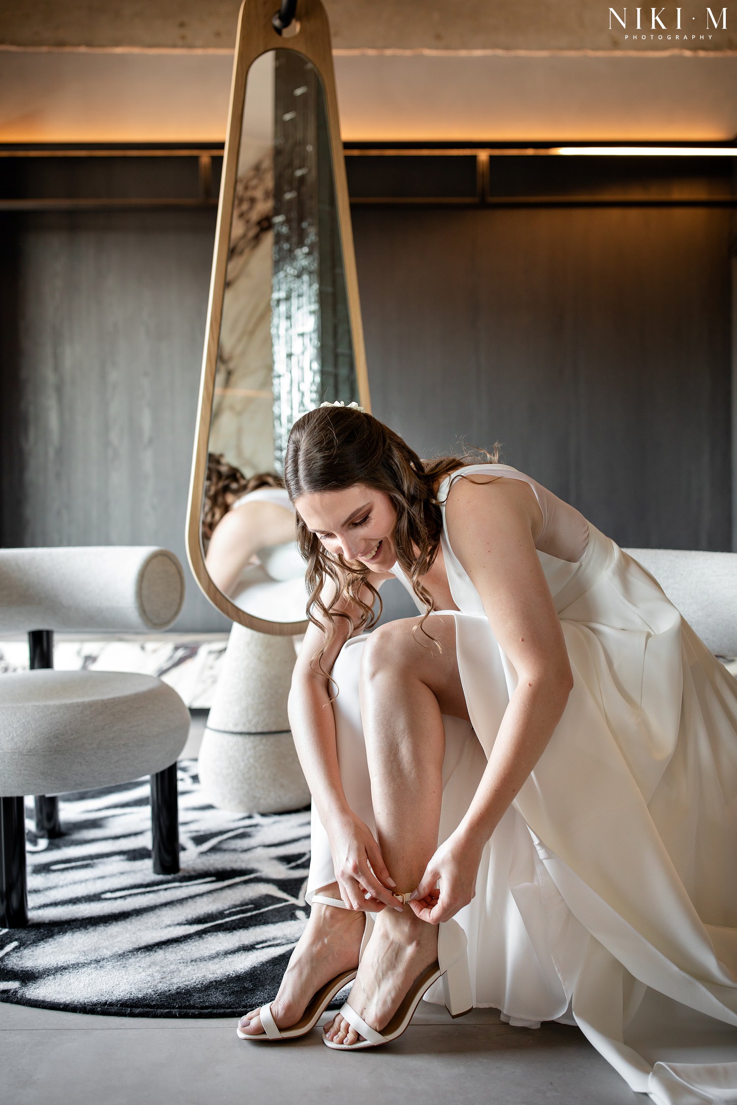Bride puts on her shoes in the Hallmark House Penthouse bathroom whilst prepping for her Johannesburg inner city wedding