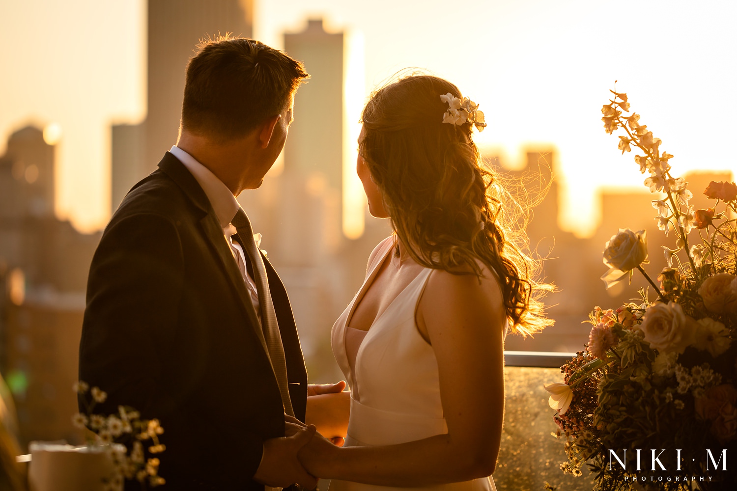 Cake cutting overlooking the inner city skyline at a Johannesburg wedding during sunset