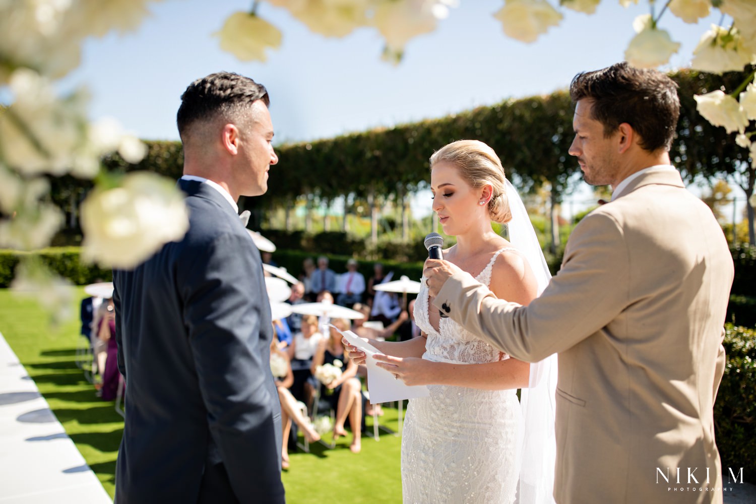 Cavalli Estate wedding in the sunken garden with white rose floral arch