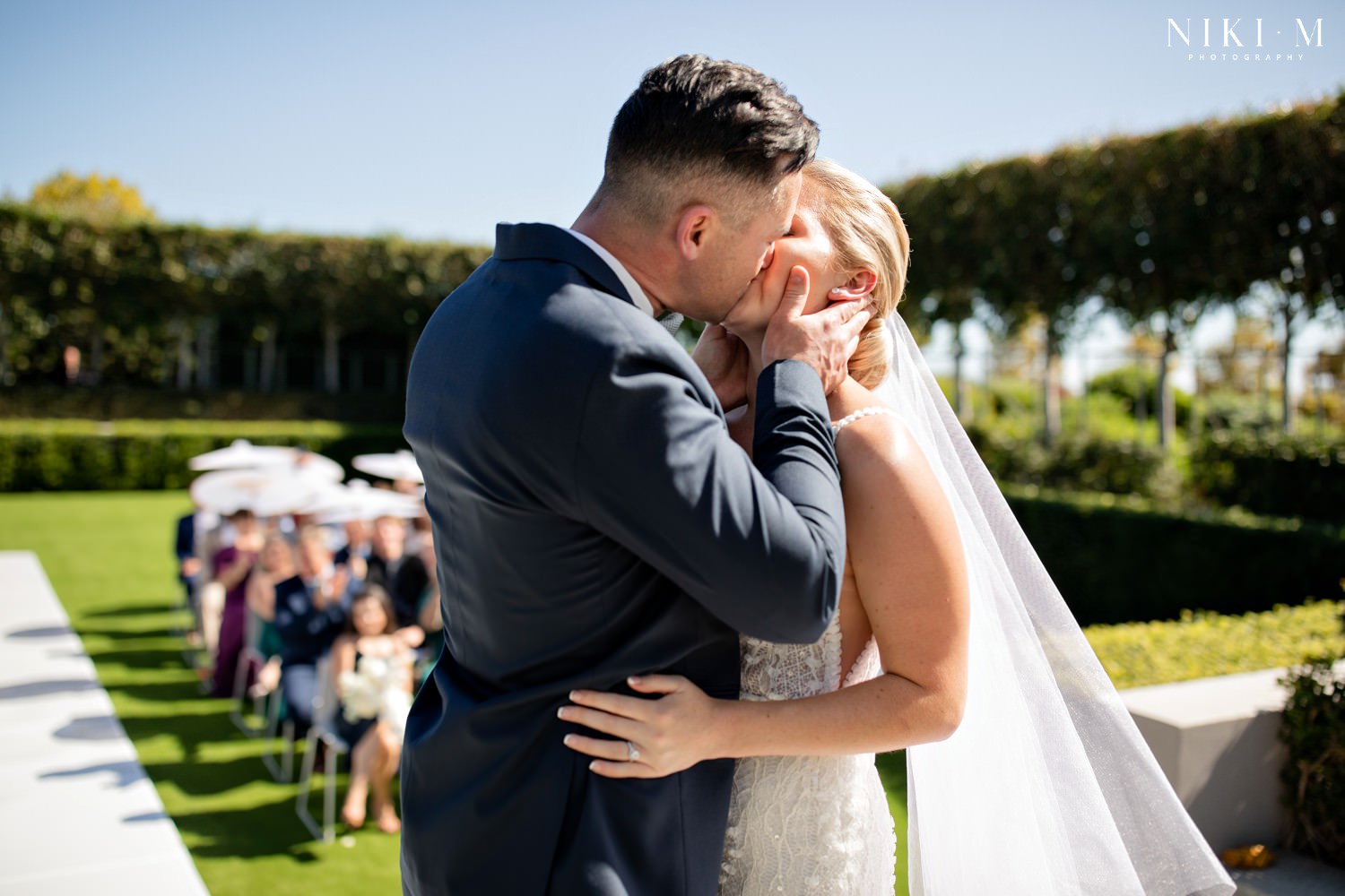 First kiss in the sunken garden at a Cavalli Estate wedding