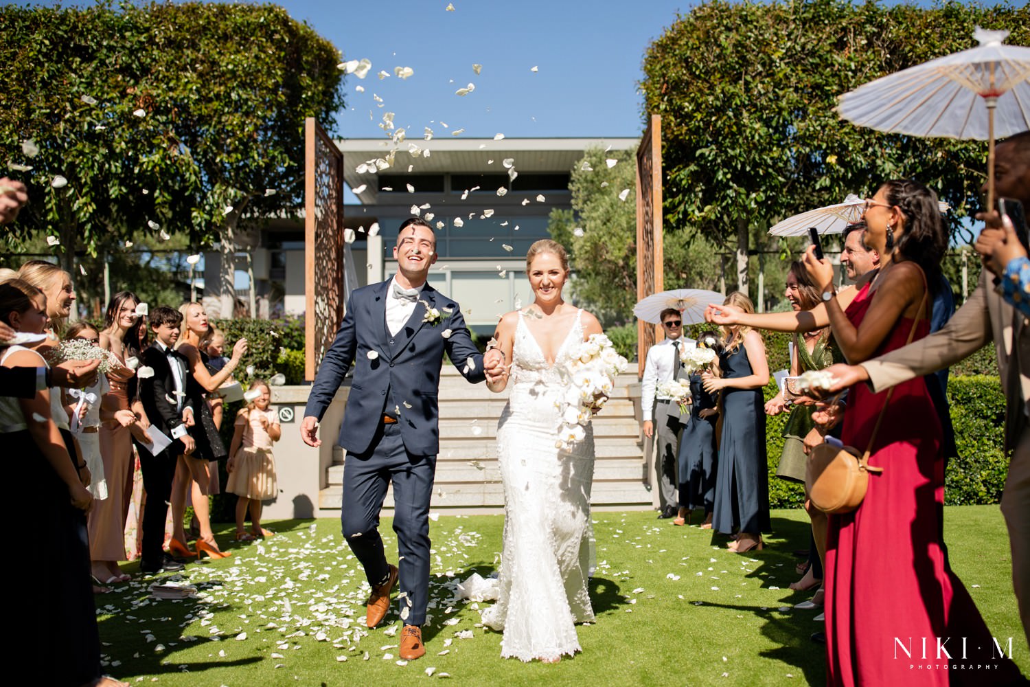 White rose petal toss in the sunken garden at a Cavalli Estate wedding in Cape Town