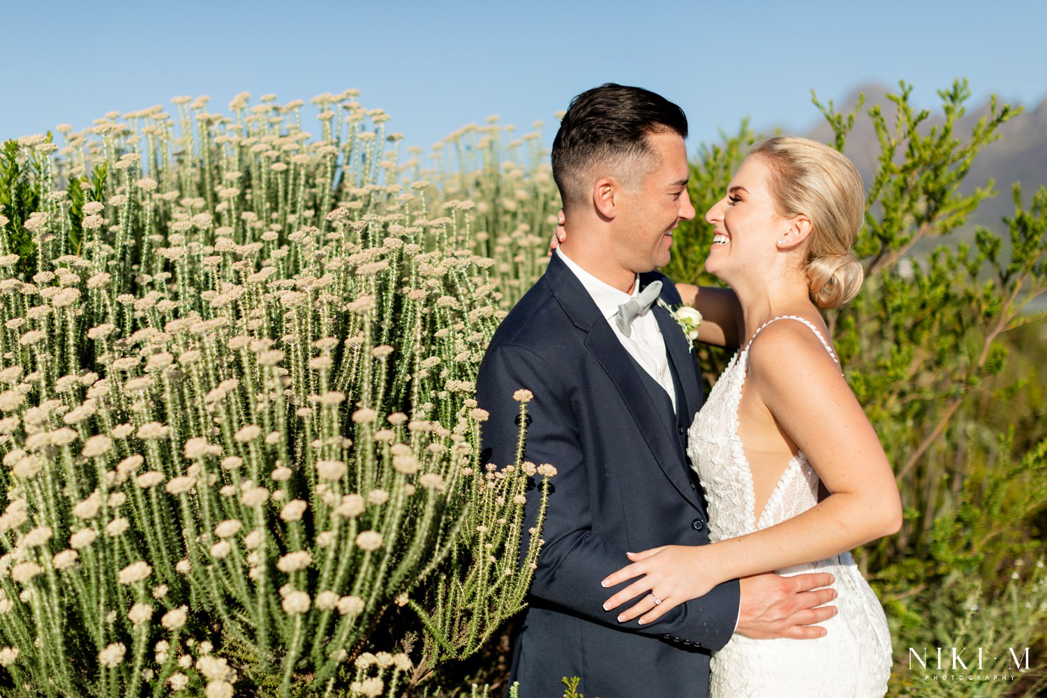 Bride and groom photographed in the fynbos gardens at their Cavalli Estate wedding