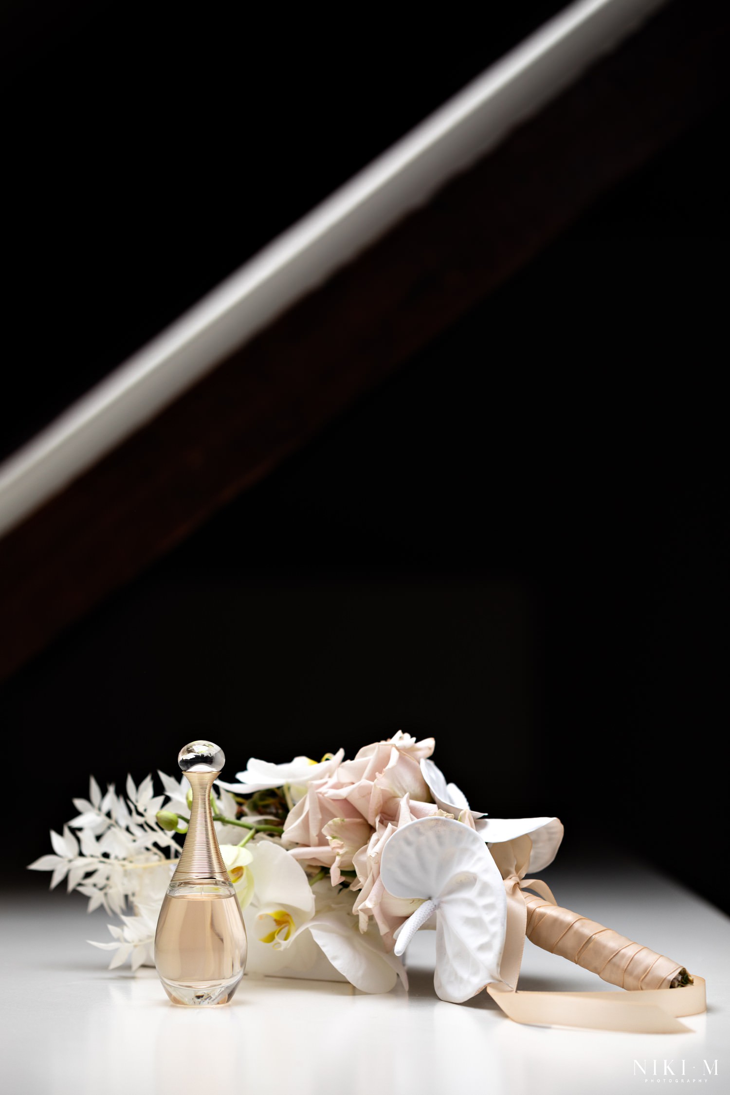 A blush and white bridal bouquet featuring white anthuriums and white orchids