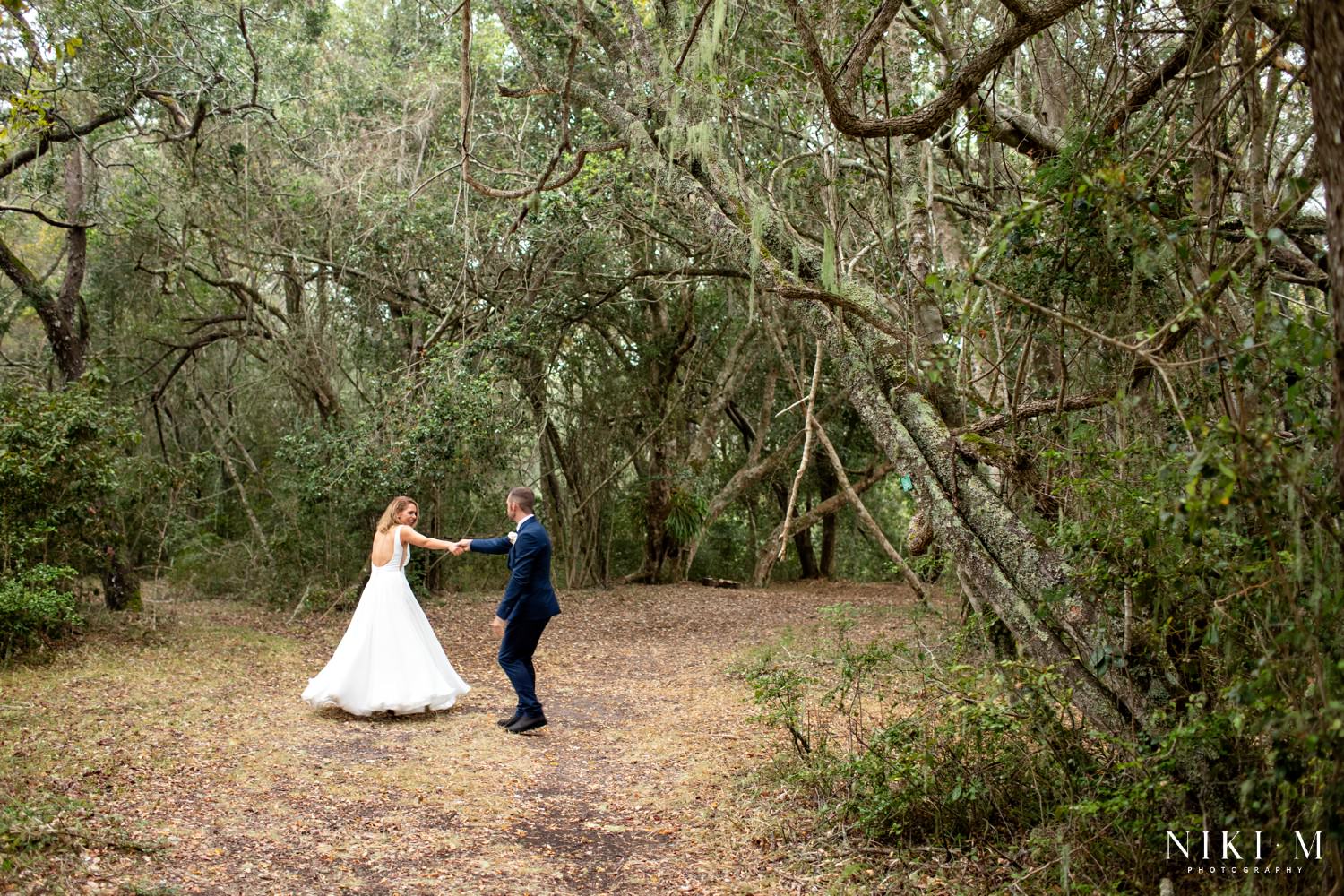 Lexi and Luke, the bride and groom, dance in the indigenous forest on the property of Forest Hall Estate.