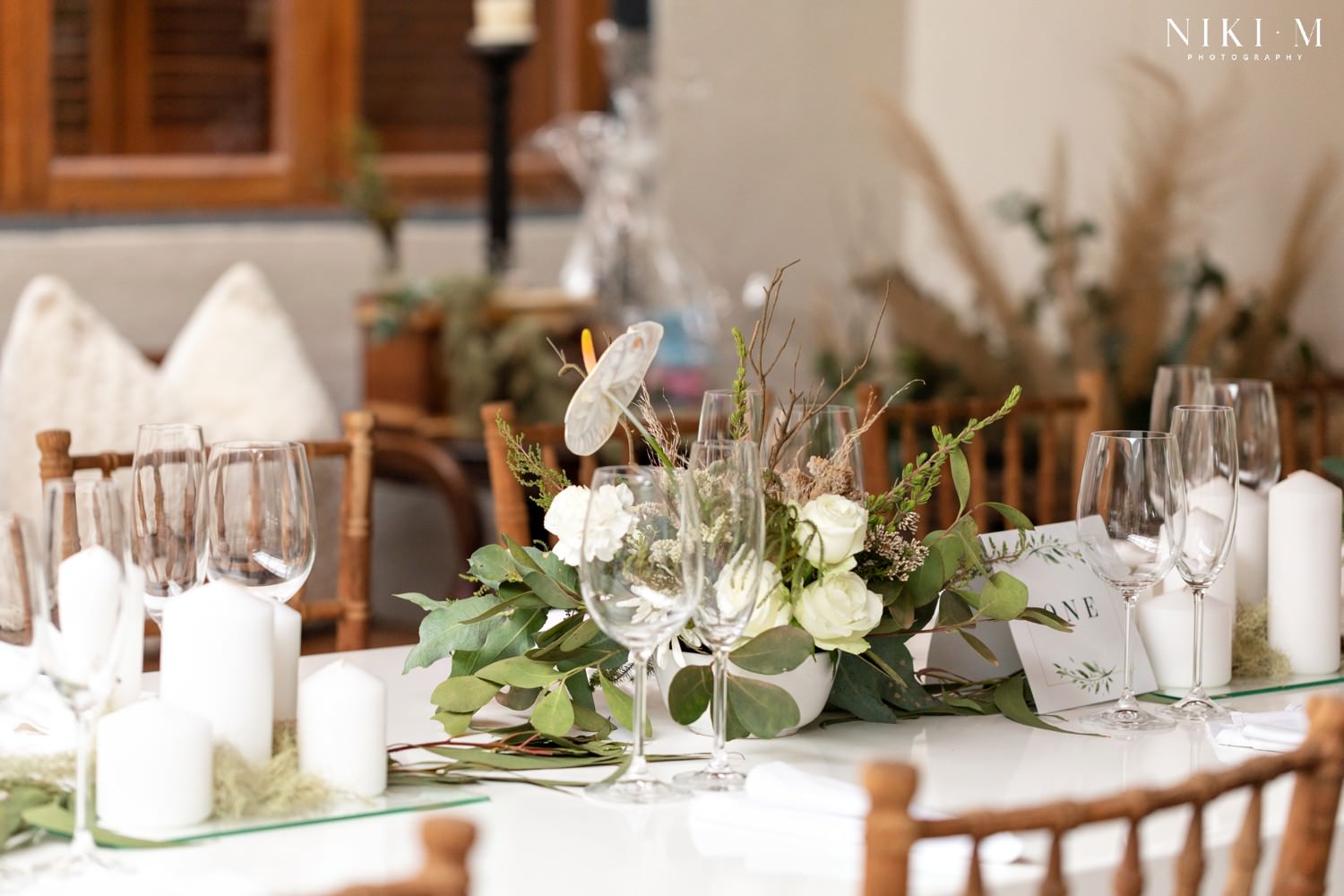 White wedding decor at a DIY wedding in the Garden Route. The bride and groom hosted their wedding at Forest Hall and we discuss just how they pulled it off in this guide about how to plan your DIY wedding.