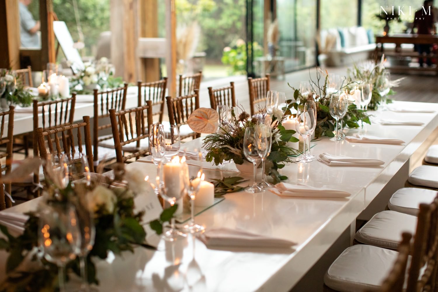 Beautiful, clean white wedding decor and flowers, accented with candles to create ambience.