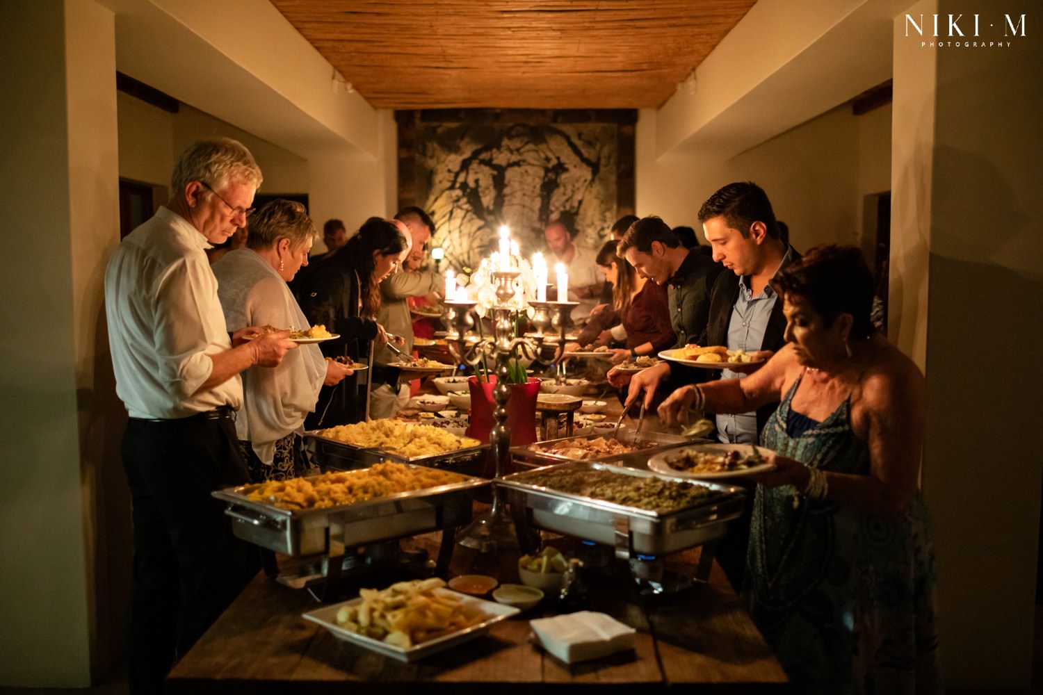 Guests dish up food made by the bride's parents. Lexi's folks served up a beautiful meal to help out with their DIY wedding, and if you'd like to find out how you can ask for help from your friends and family, then this article is for you!