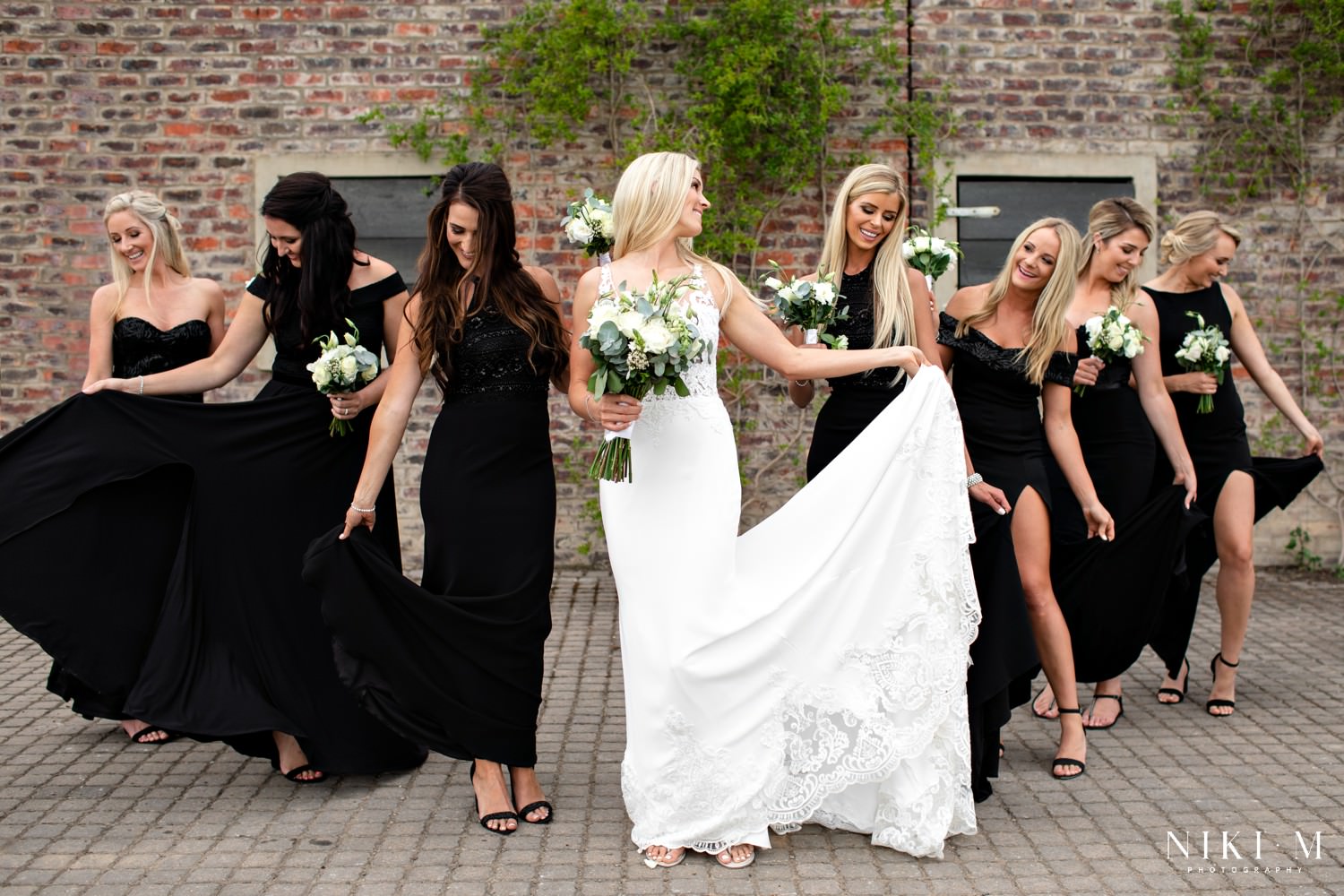 Large group of bridesmaids photographed with the bride