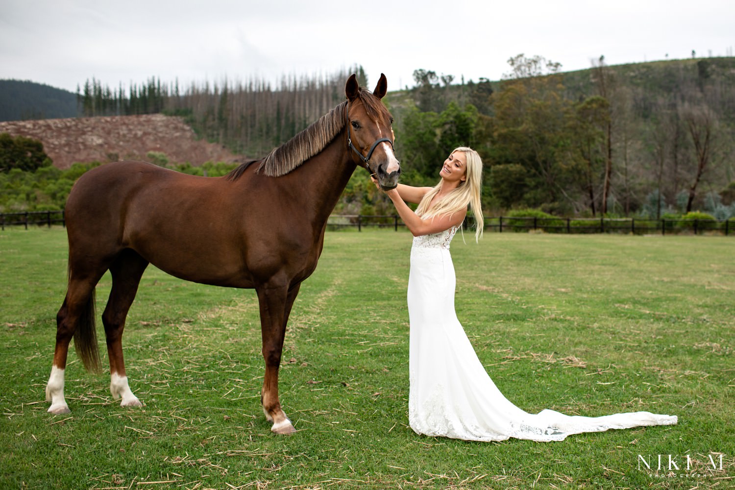 Bride photographed with her horse in the fields of Kay and Monty Vineyard wedding venue outside Plettenberg Bay