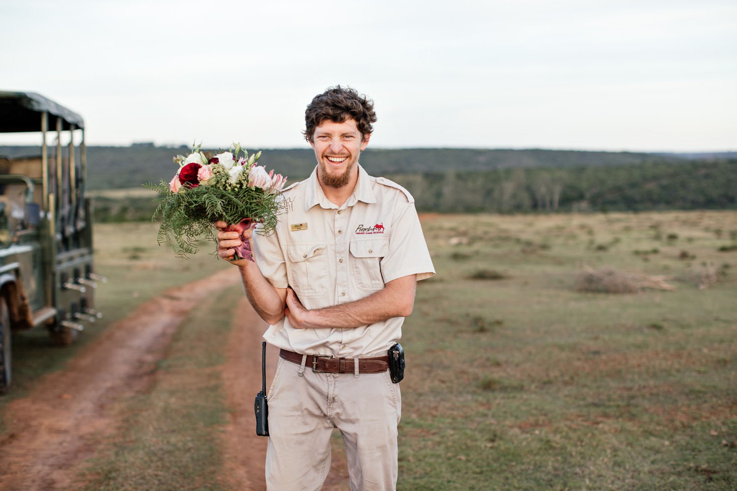 Pumba Lodge's game ranger helps out with the bridal bouquet. Image by safari photographer Niki M