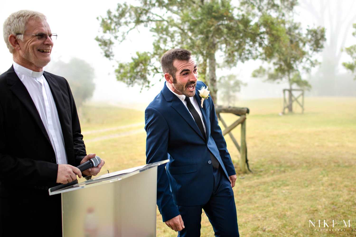 Luke (the groom) excitedly looks around guests to try get a glimpse of his bride Lexi