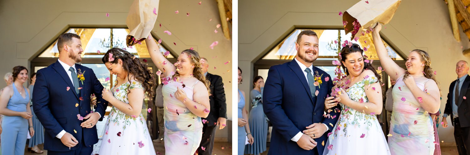 Guests celebrate as flower petals shower the couple during their joyful Champagne Castle Hotel ceremony, capturing a candid Drakensberg wedding moment full of laughter and colour.