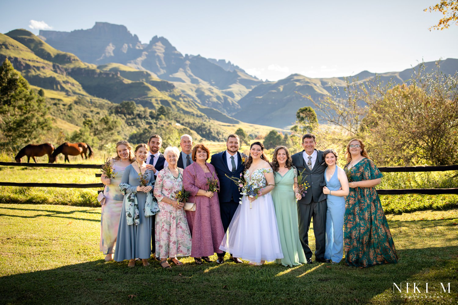 Family portrait with mountains and wild horses in the background at this Central Drakensberg wedding — a picture-perfect setting for a heartfelt micro-wedding celebration.