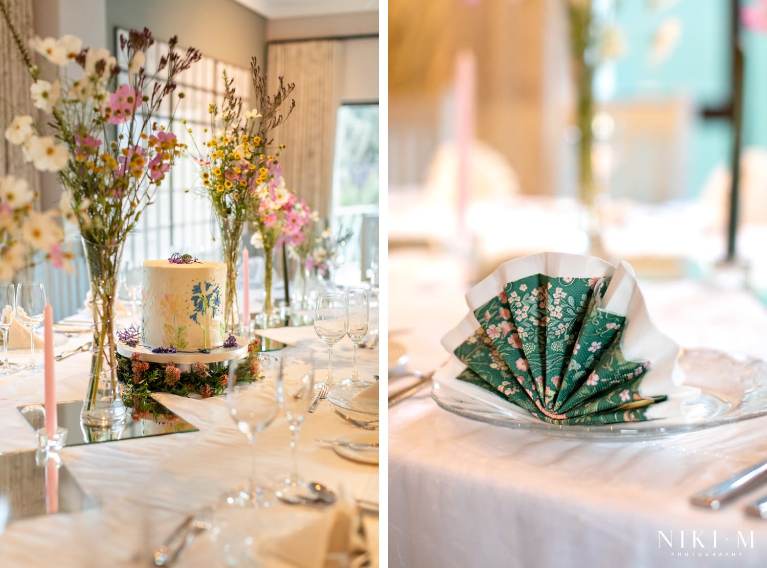 Close-up of a wildflower-inspired wedding cake surrounded by delicate greenery and pink cosmos at the Drakensberg wedding reception.