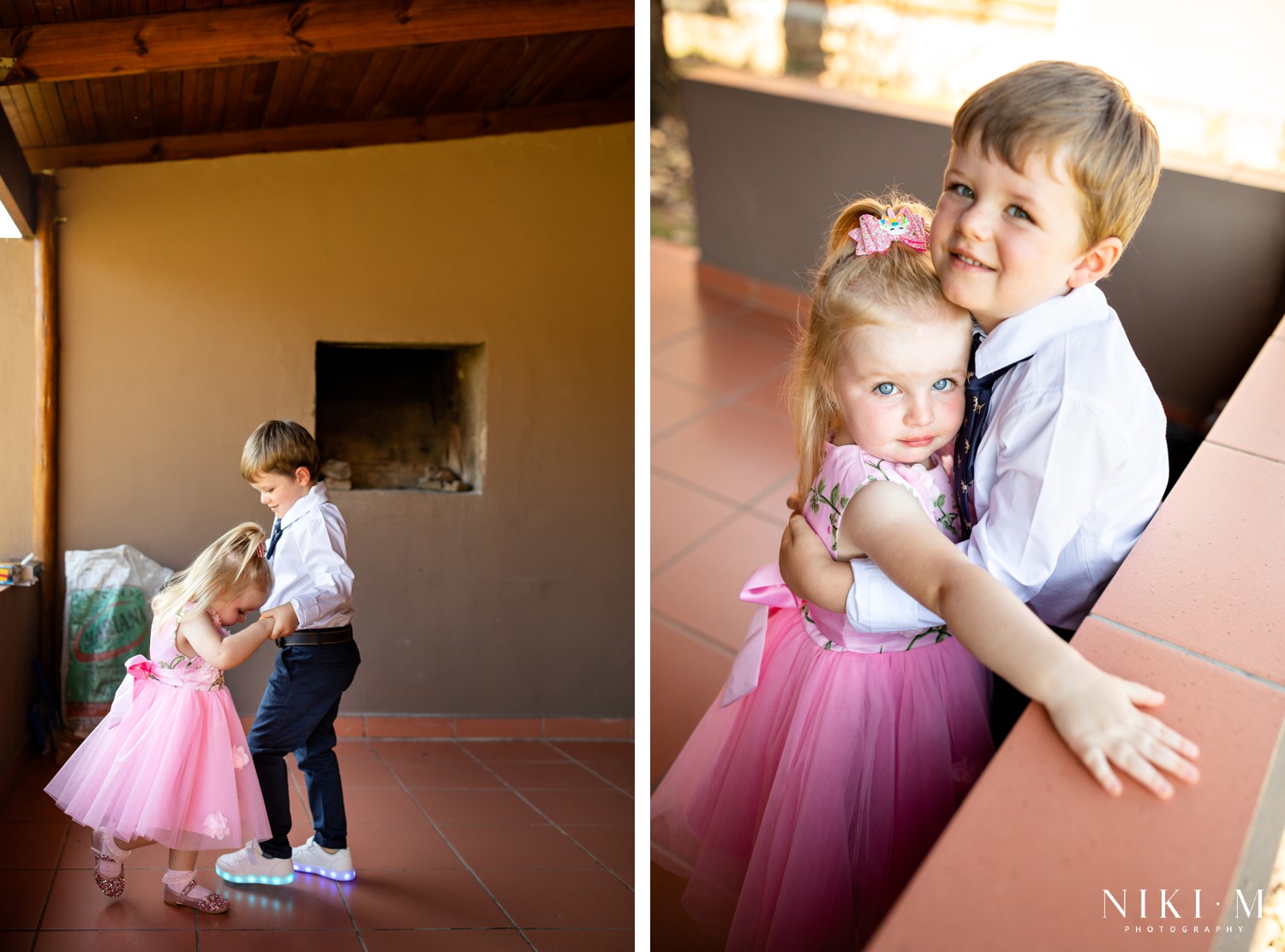 Flower girl in pink tulle and page boy in navy suit laughing together at a Champagne Valley wedding