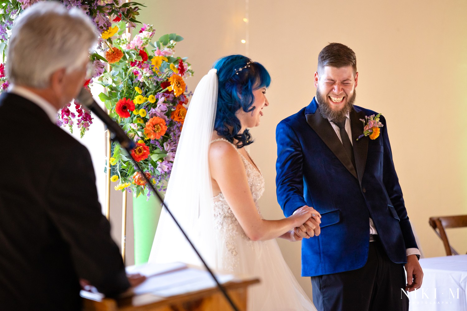 Groom laughing out loud during his wedding vows at a Drakensberg wedding in Champagne Valley