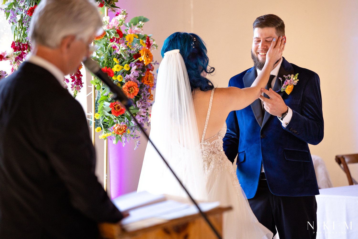 Bride wiping tears from her groom's face at the altar at a Champagne Valley wedding ceremony