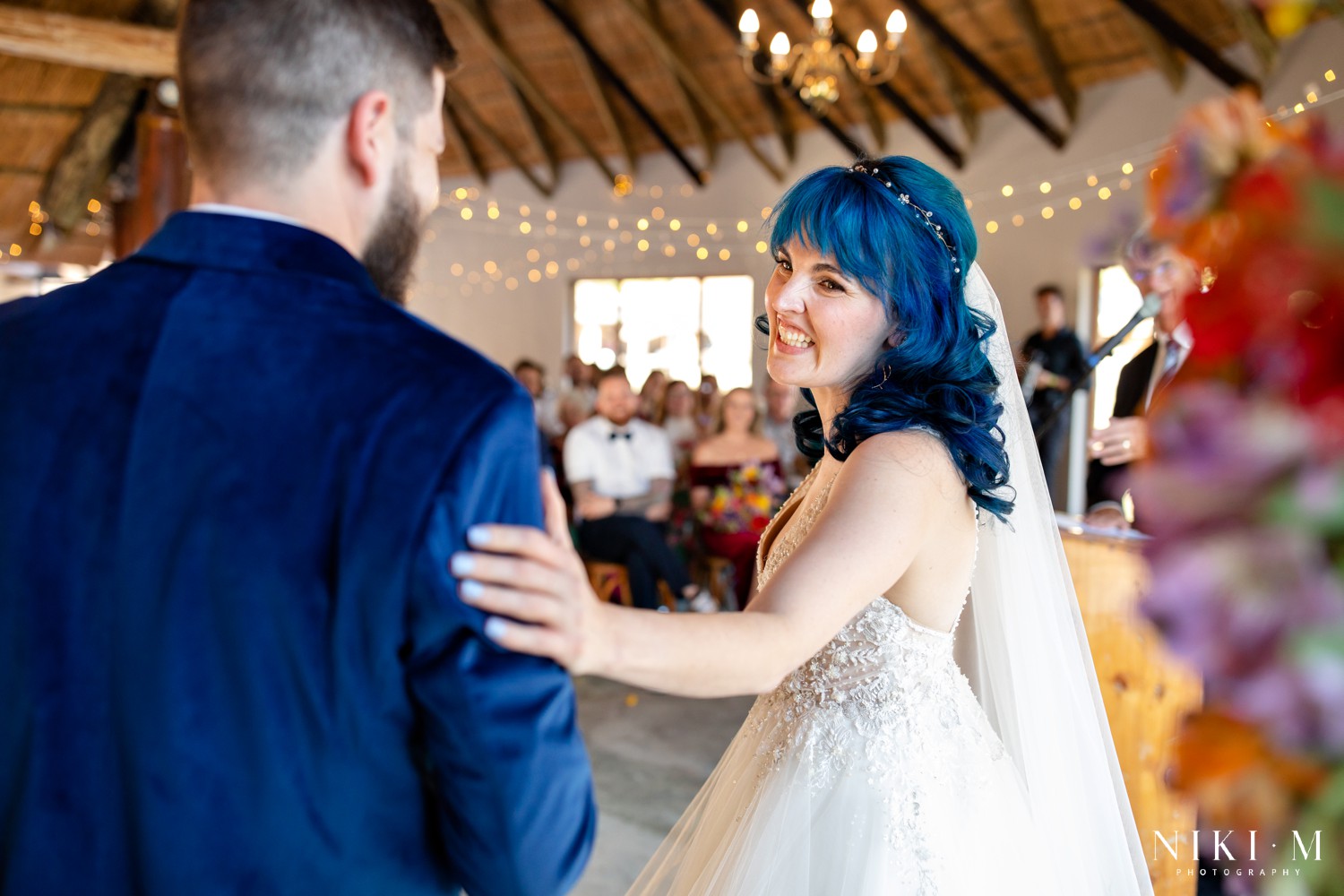 Bride beaming at her groom during their Drakensberg wedding ceremony in Champagne Valley