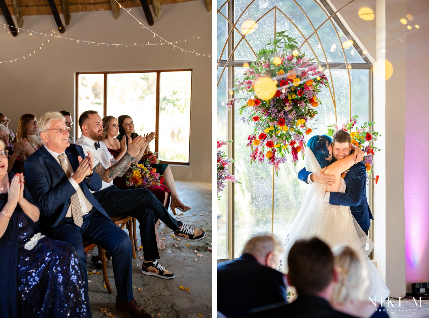 First kiss with the groom's fist raised in celebration beneath the floral arch at a Champagne Valley wedding
