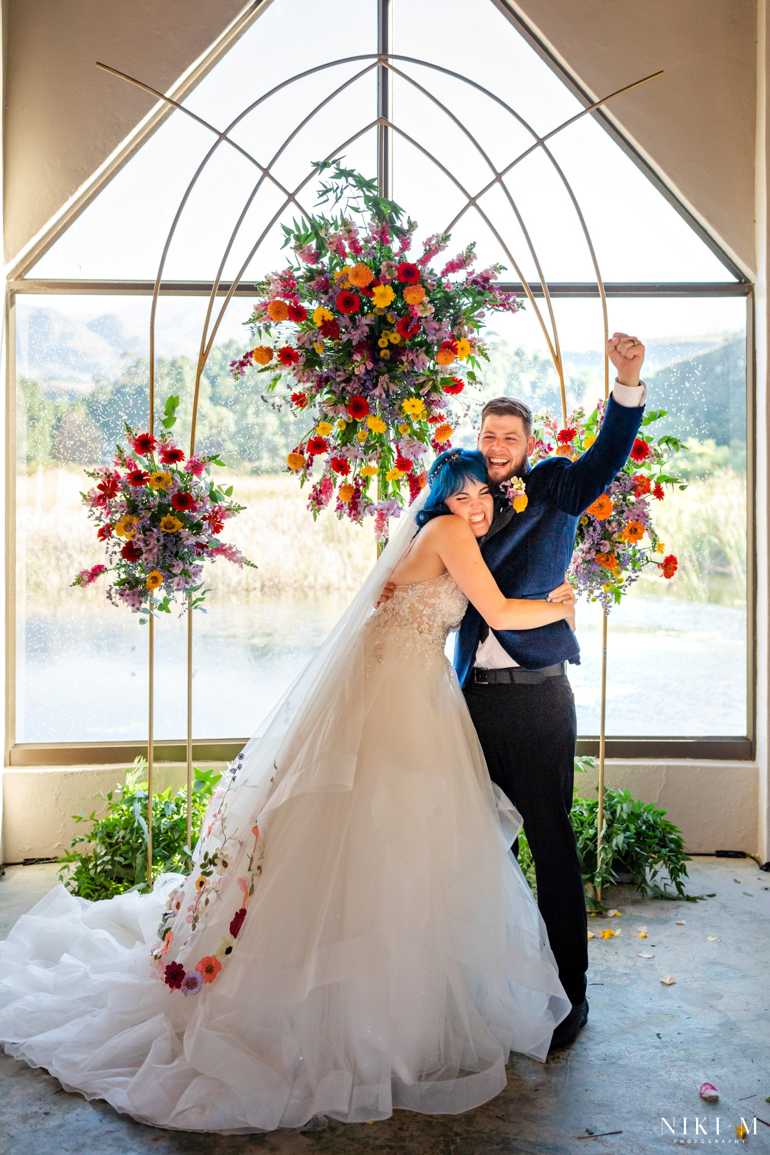 Newlyweds laughing and embracing together after their ceremony at a Champagne Valley Drakensberg wedding