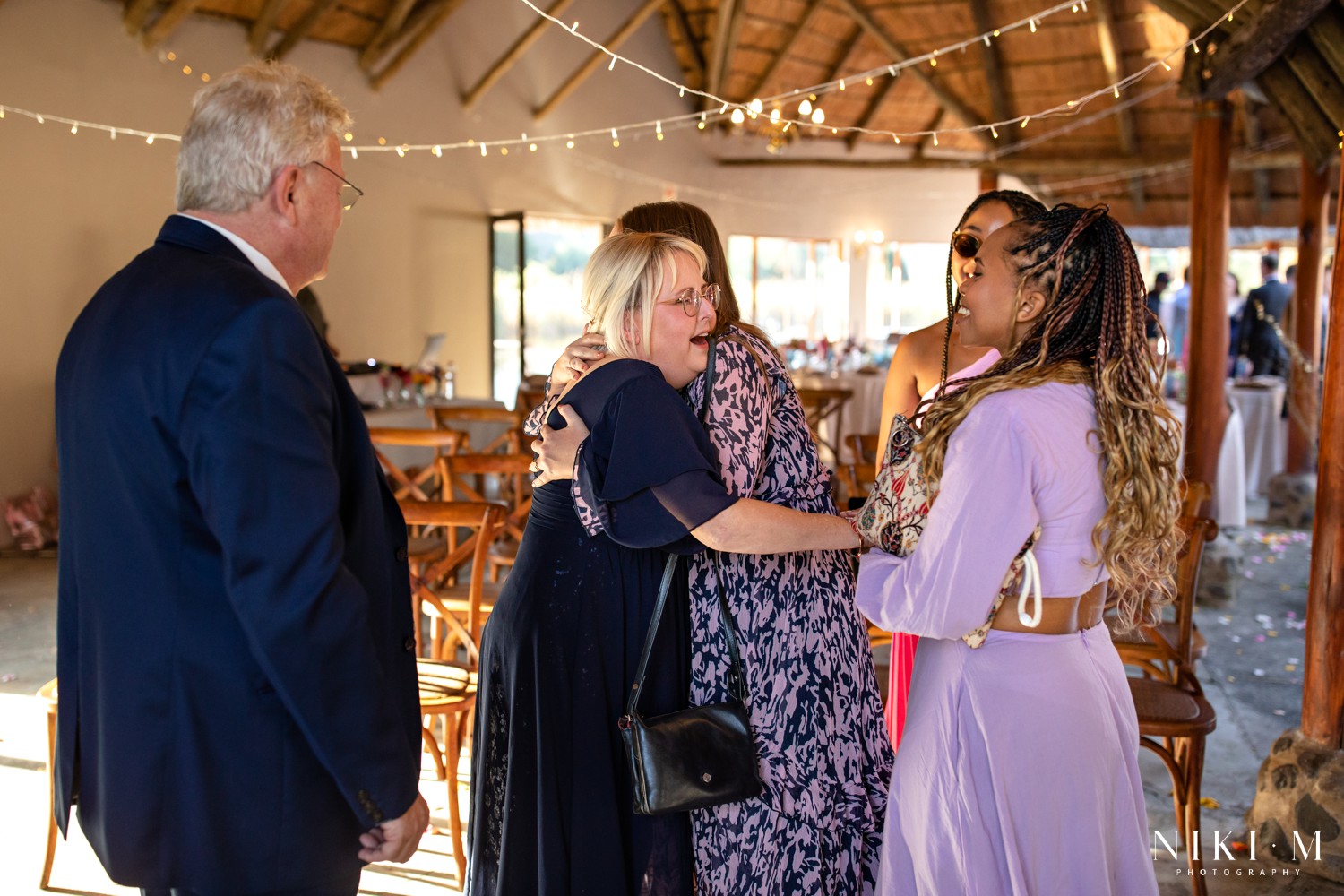 Guests celebrating and embracing in the reception area after the ceremony at a Drakensberg wedding