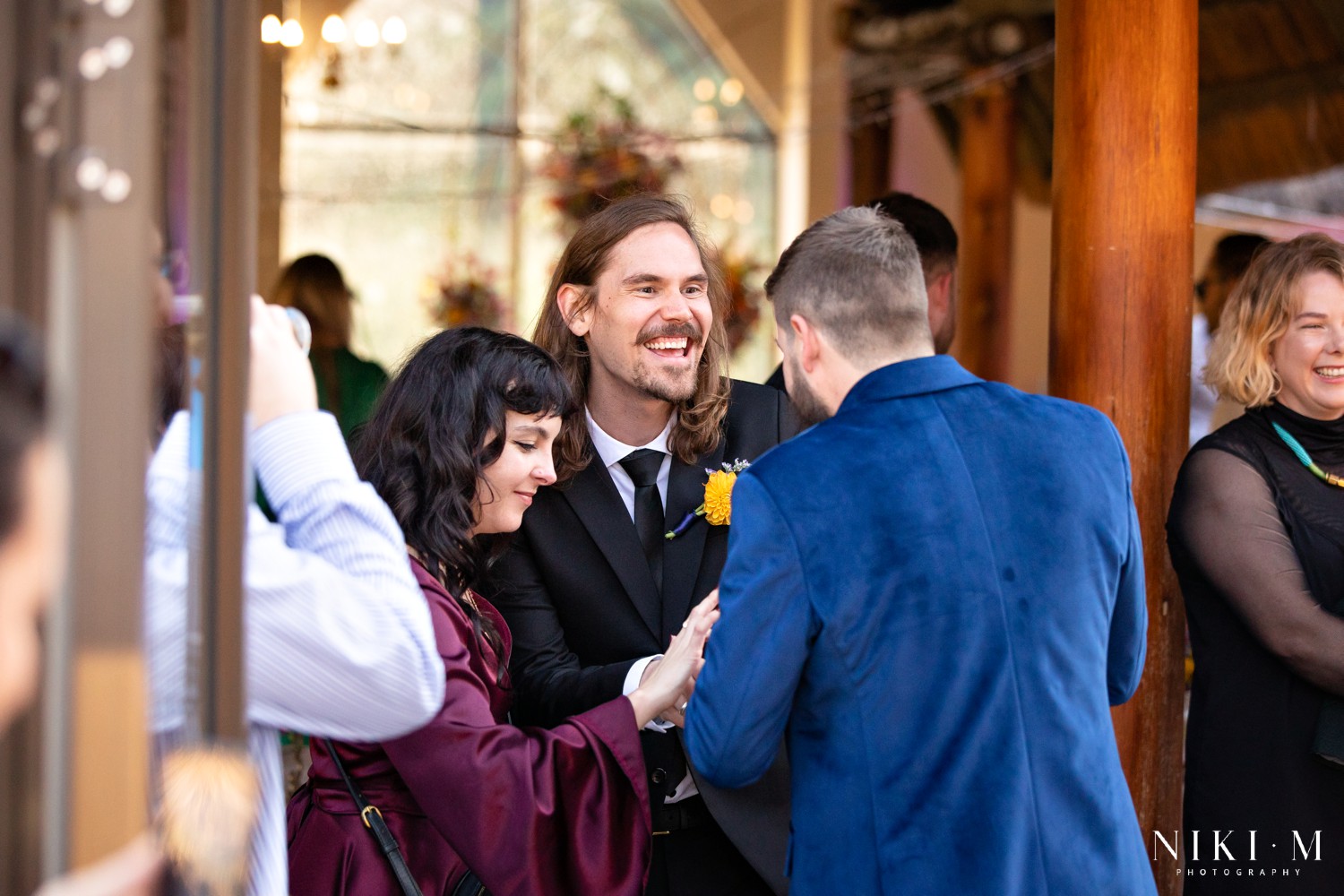 Groom greeting guests warmly after the ceremony at a Champagne Valley Drakensberg wedding