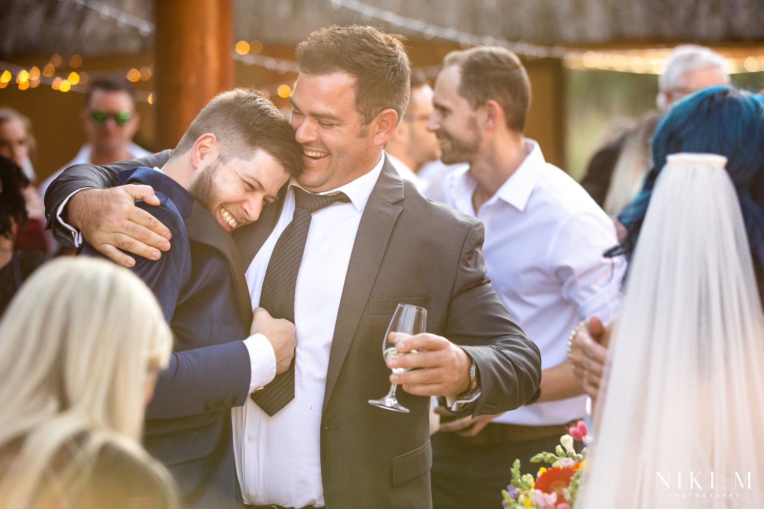 Groom embracing his brother in golden afternoon light after the ceremony at a Drakensberg wedding