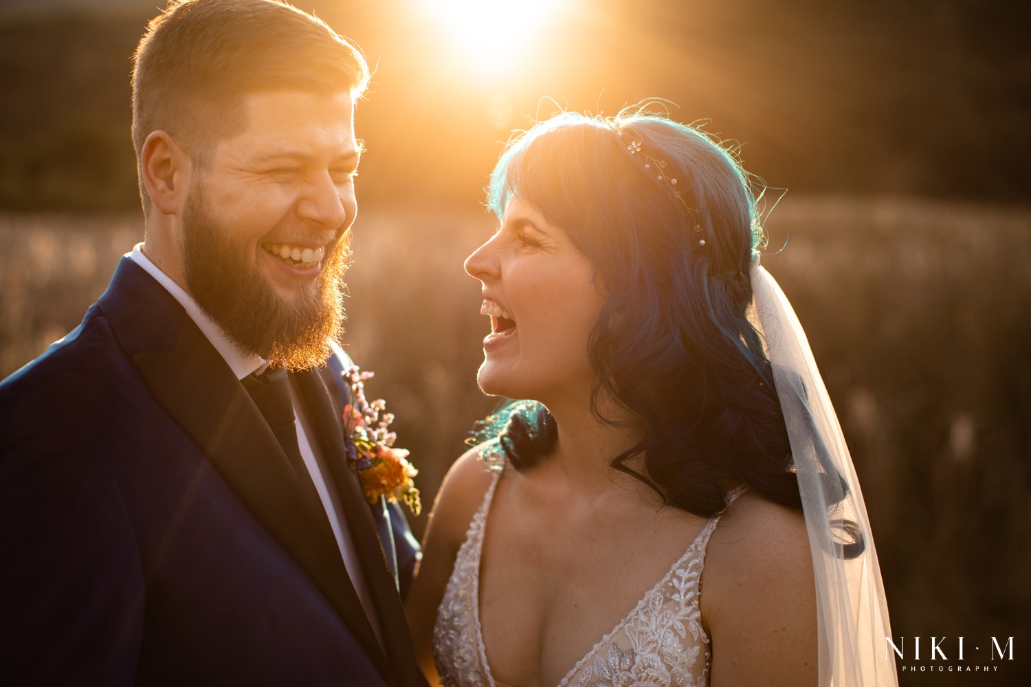 Intimate couple portrait of Emily and Bern laughing together at golden hour, Champagne Valley Drakensberg wedding