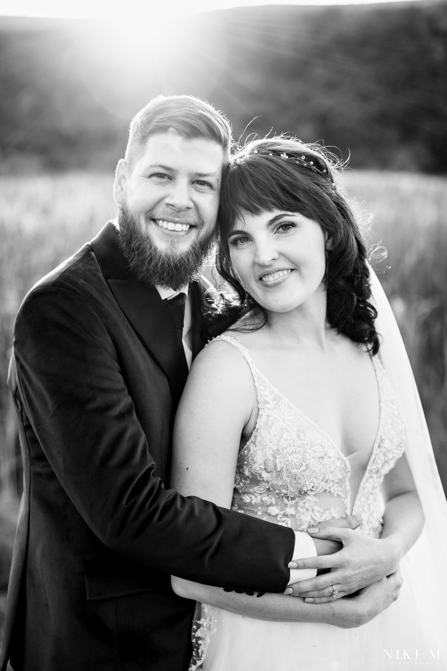 Black and white couple portrait of Emily and Bern smiling together at golden hour, Champagne Valley Drakensberg wedding