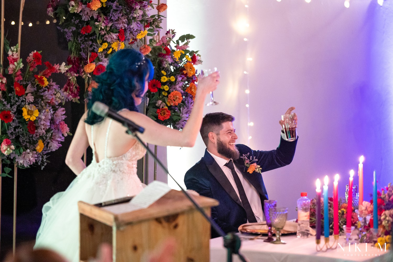 Bride and groom raising their glasses in a toast during speeches at a Drakensberg wedding in Champagne Valley